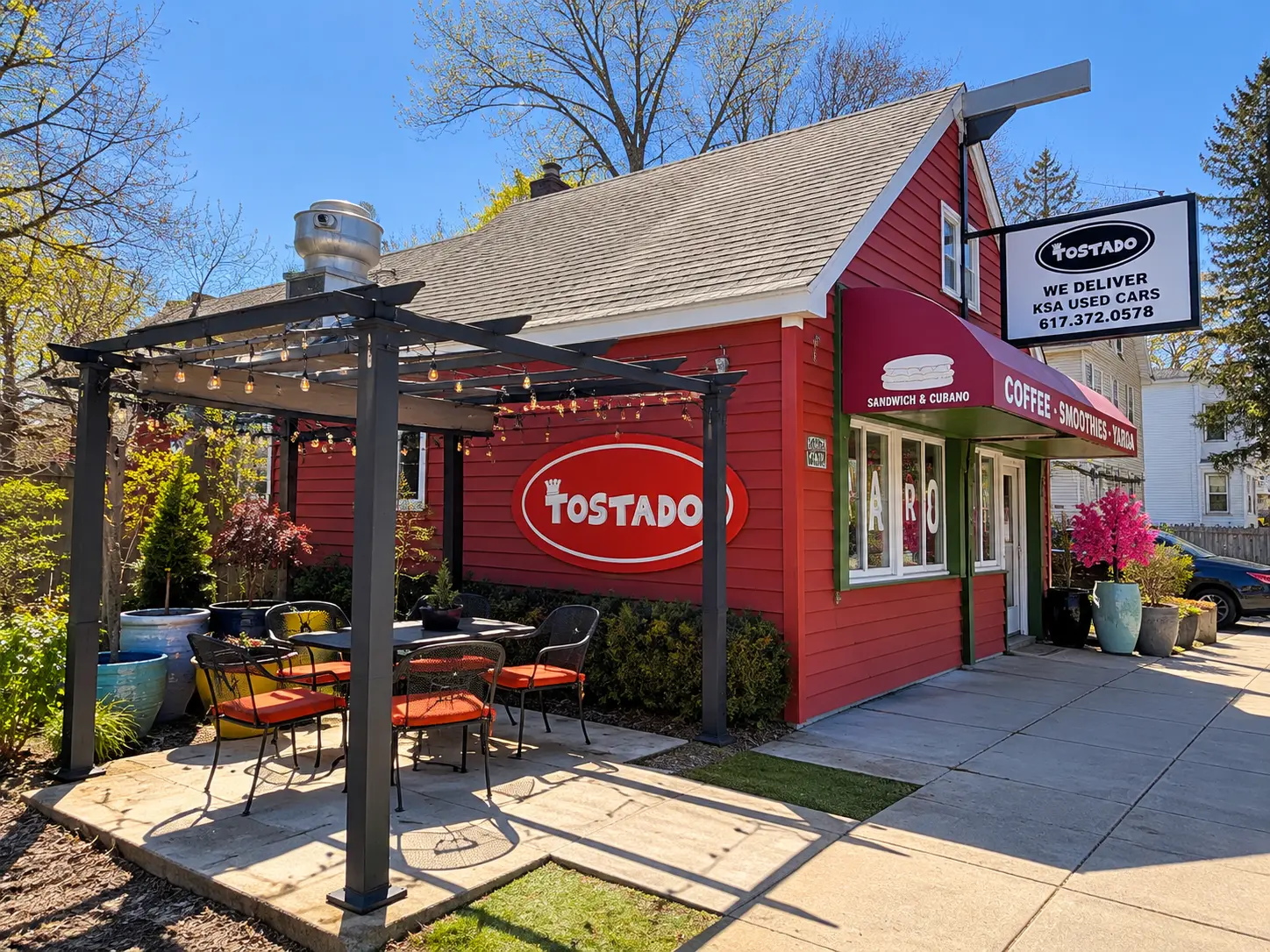Tostado red building with an outdoor patio, string lights and colorful planters